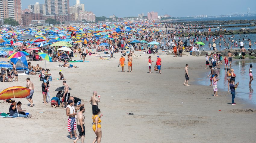 NEW YORK, NEW YORK – JULY 04: People visit the crowded beach at Coney Island as the city moves into Phase 2 of re-opening following restrictions imposed to curb the coronavirus pandemic on July 4, 2020 in New York City. Phase 2 permits the reopening of offices, in-store retail, outdoor dining, barbers and beauty parlors and numerous other businesses. Phase 2 is the second of four-phased stages designated by the state.  (Photo by Alexi Rosenfeld/Getty Images)