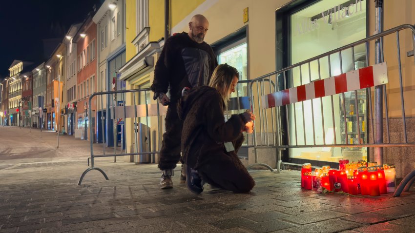 A person lights a candle