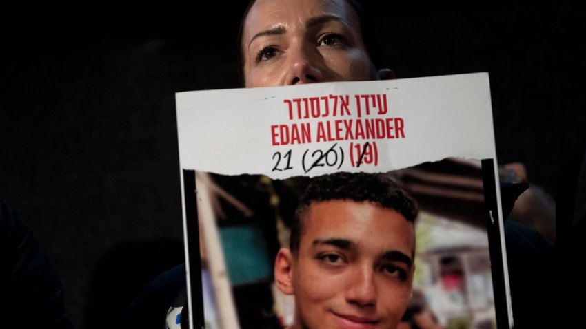 Yael Alexander holds a poster of her son, Edan, who was taken hostage by Hamas militants on Oct. 7, 2023, during a weekly rally for families of hostages held in the Gaza Strip and their supporters, in Tel Aviv, Israel, Saturday, Feb. 22, 2025. (AP Photo/Maya Alleruzzo)