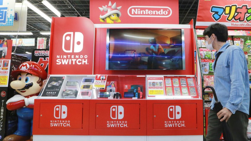 FILE – A man walks by a Nintendo Switch display at an electronics retail chain store in Tokyo, on Oct. 13, 2021. (AP Photo/Koji Sasahara, File)