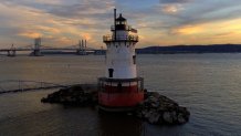 FILE - The Sleepy Hollow Lighthouse at Kingsland Point Park sits on the Hudson River at sunset, July 26, 2017, in Sleepy Hollow, N.Y. (AP Photo/Julie Jacobson, File)